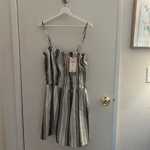 White and black striped sundress, adjustable strap and button top. Stretchy top